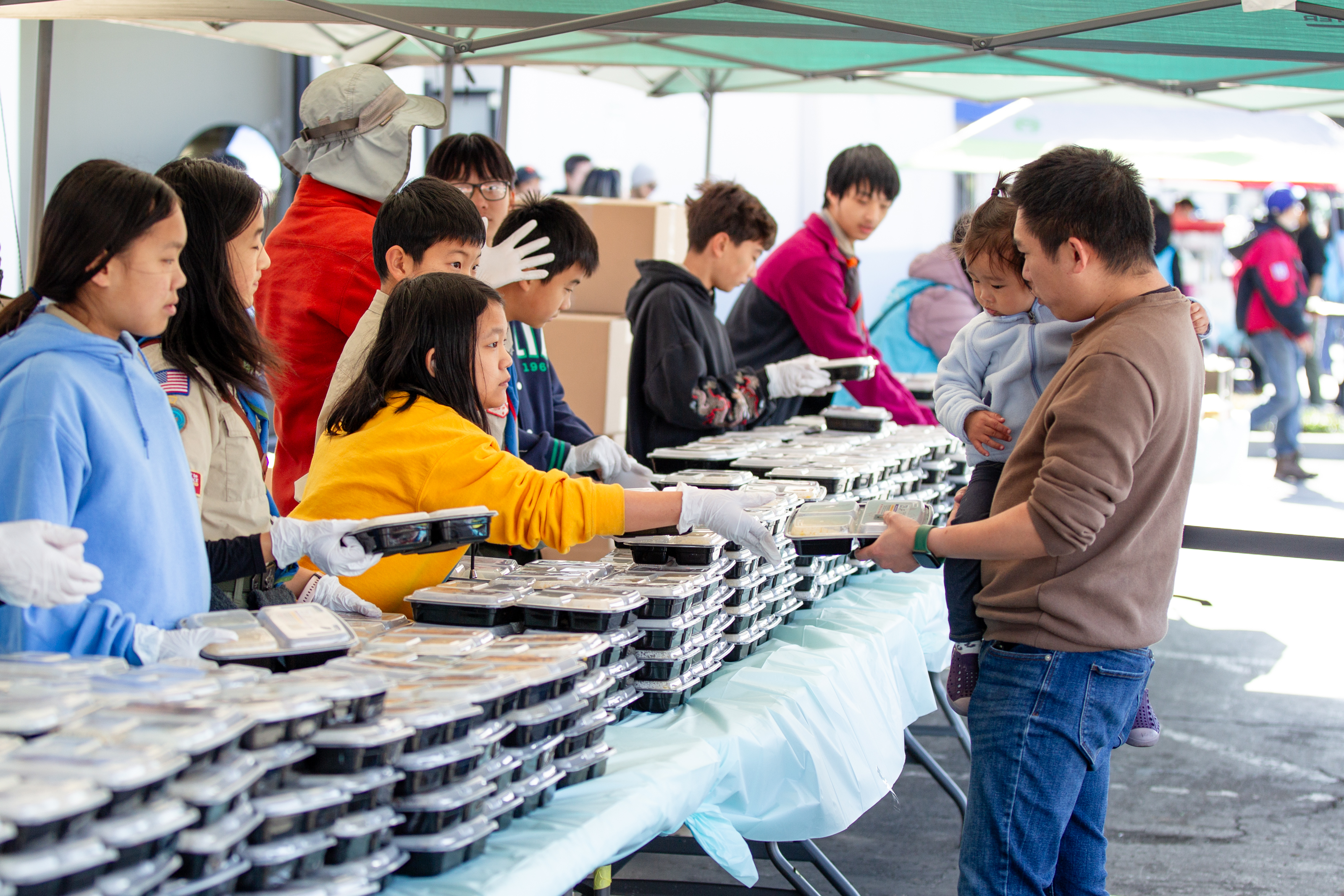 Food line with families sharing a warm meal